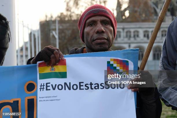 Protester holds a placard that says Evo you are not alone in London during the rally. People gathered outside Downing Street to raise their voices...