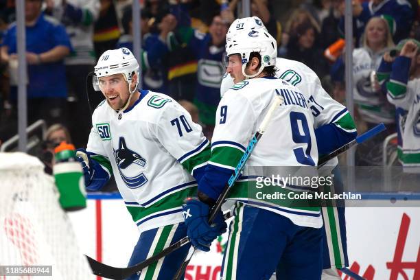 Tanner Pearson, J.T. Miller and Tyler Myers of the Vancouver Canucks celebrate a goal against the Edmonton Oilers at Rogers Place on November 30,...