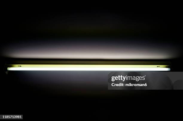 glowing fluorescent, strip light, glow tube - luce fluorescente foto e immagini stock