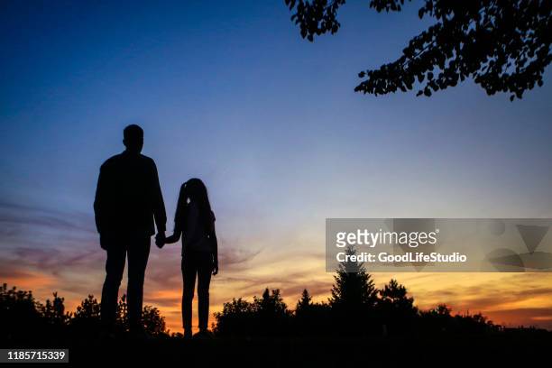 father and daughter - child standing silhouette stock pictures, royalty-free photos & images