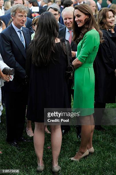 Catherine, Duchess of Cambridge mingles with guests including television producer Nigel Lythgoe during a private reception at the British...