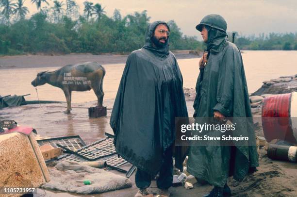 American film director Francis Ford Coppola speaks with actor Martin Sheen on the set of their film, 'Apocalypse Now' , Philippines, 1978. Behind...