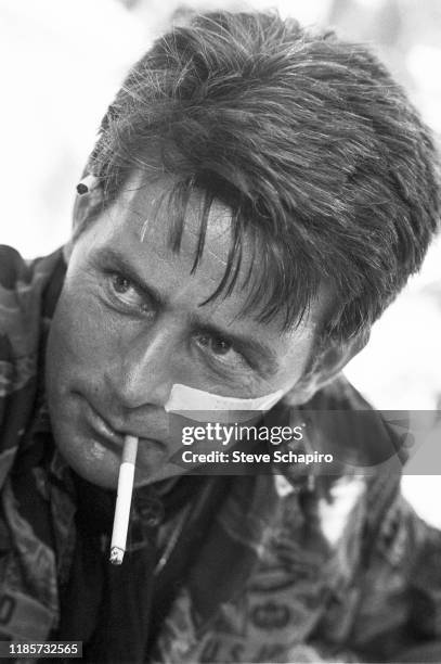 Close-up of American actor Martin Sheen, a cigarette in his mouth, on the set of his film, 'Apocalypse Now' , Philippines, 1978.