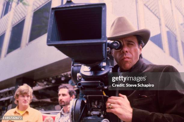 American film director Peter Bogdanovich looks though a camera on the set of his film 'They All Laughed,' New York, New York, 1980.