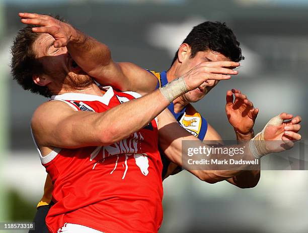 Zach Tuohy of the Bullants is taken high by Paul Cahill of the Bullants during the round 15 VFL match between Sandringham and the Northern Bullants...