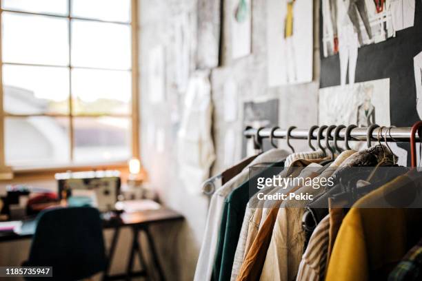 clothes hanging in modern boutique - hanging blouse stock pictures, royalty-free photos & images