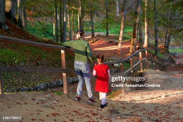 climbing the old alley mother and daughter, at sunset visiting the fortress at sarmizegetusa regia, romania, europe. - sarmizegetusa regia stock pictures, royalty-free photos & images