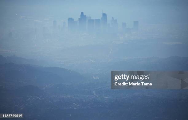 The buildings of downtown Los Angeles are partially obscured at midday on November 5, 2019 as seen from Pasadena, California. The air quality for...