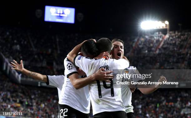 Manu Vallejo, Jose Luis Gaya and Maximiliano Gomez of Valencia celebrate their team's second goal which was an own goal scored by Adama Soumaoro of...