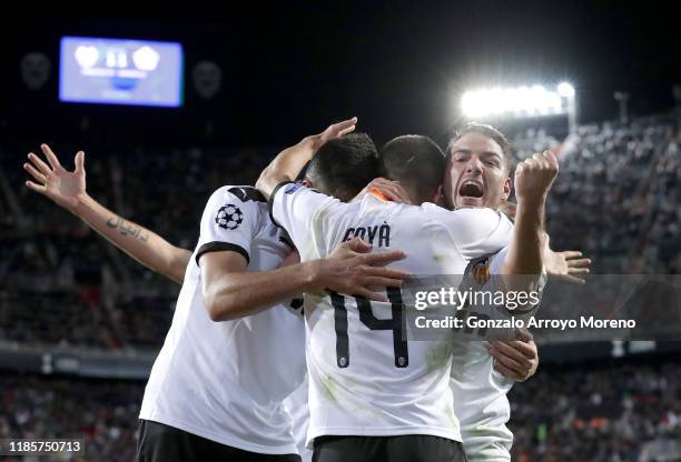 Manu Vallejo, Jose Luis Gaya and Maximiliano Gomez of Valencia celebrate their team's second goal which was an own goal scored by Adama Soumaoro of...