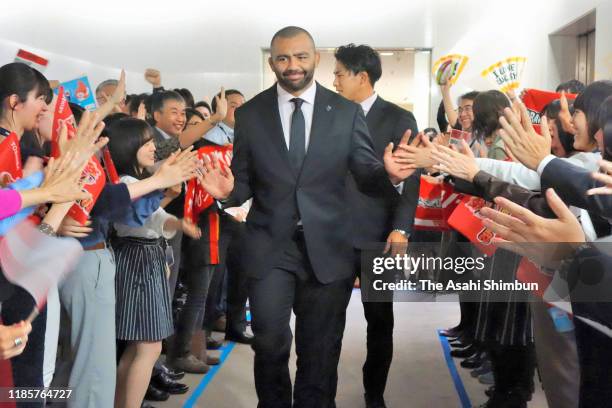 Michael Leitch and Yoshitaka Tokunaga high five with staffs during their visit the Toshiba headquarters on November 5, 2019 in Tokyo, Japan.