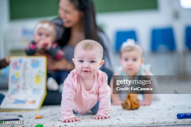 liten flicka kryper i en dagis rum stock foto - baby crawling away bildbanksfoton och bilder