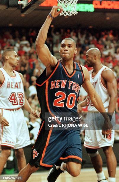 Allan Houston of the New York Knicks celebrates his game-winning shot in front of P.J. Brown and Alonzo Mourning of the Miami Heat16 May 1999 during...