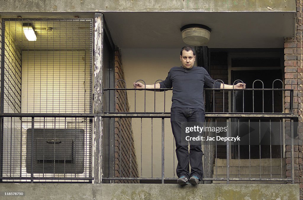 Housing estate dweller hanging out from staircase