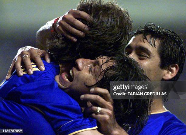 Jorge Bermudez and Cristian Traverso celebrate with Guillermo Barros Schelloto of Boca Juniors of Argentina, after the second goal of his team...