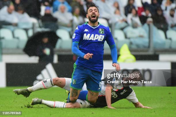 Francesco Caputo of US Sassuolo competes for the ball with Miralem Pjanic of Juventus during the Serie A match between Juventus and US Sassuolo at on...