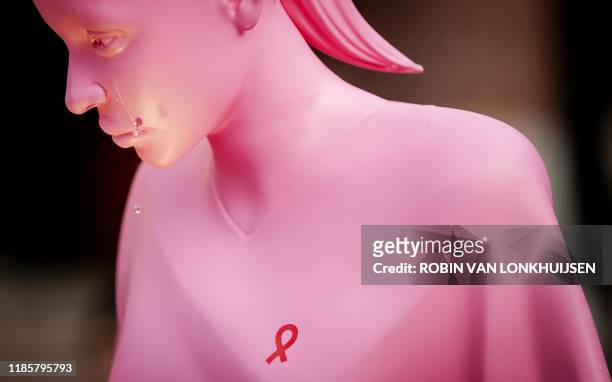 Photo shows a 3D printed statue of the Dutch AIDS foundation unveiled in the center of Amsterdam, on December 1, 2019. - The statue sheds a tear...