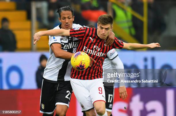 Krzysztof Piatek of AC Milan competes for the ball with Bruno Alves of Parma Calcio during the Serie A match between Parma Calcio and AC Milan at...