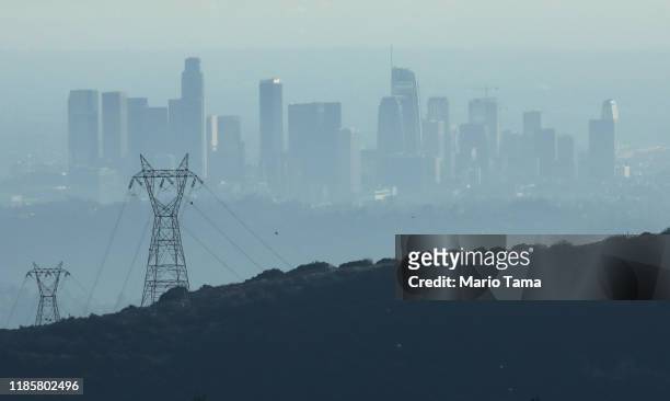 The buildings of downtown Los Angeles are partially obscured in the late afternoon on November 5, 2019 as seen from Pasadena, California. The air...