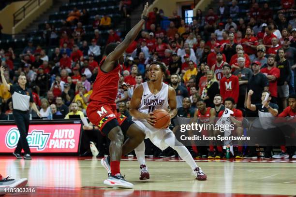 Harvard Crimson guard Bryce Aiken is defended by Maryland Terrapins guard Darryl Morsell during the 2019 Orlando Invitational mens college basketball...