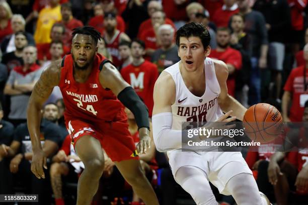 Harvard Crimson forward Danilo Djuricic drives past Maryland Terrapins forward Donta Scott during the 2019 Orlando Invitational mens college...