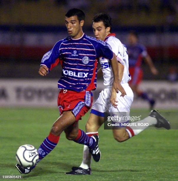 Argentina's Jaun Serrizuela escapes the Nacional team's defense by Marco del Campo during the game in Montevideo, Uruguay on 13 March 2001. El...