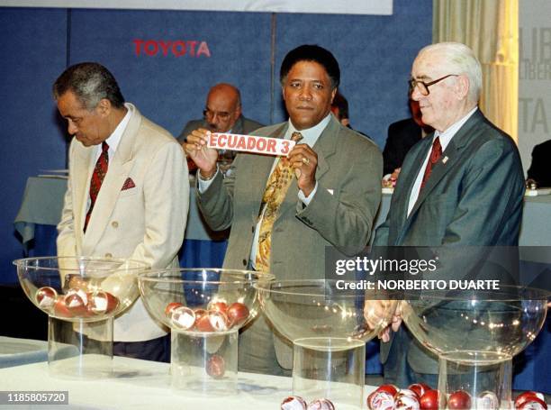 Soccer coach Francisco Maturana shows a lottery pick 11 December 1999, during the lottery for the Copa Libertadores Championship in Asuncion....