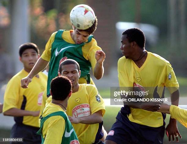 Brazil's Juninho Pernambucano fights for the ball with Roque Jr. And other teammates 11 July in Cali, Colombia. Brazil prepares for its first game...