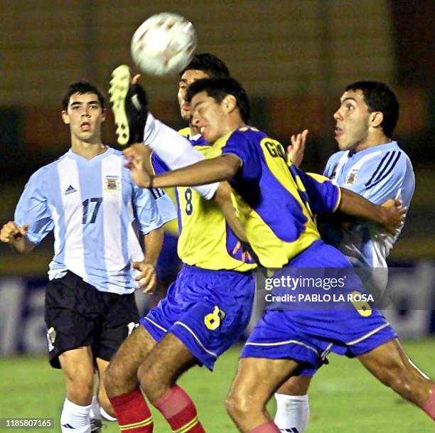 Carlos Tevez of the Argentine team battles over the ball with Colombian players Andres Gonzalez , and Fabian Montoya, 28 January 200, at the...