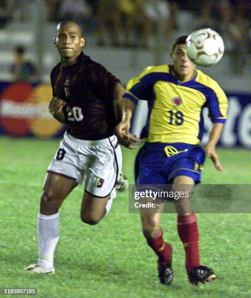 Alejandro Acosta , player of the Colombian soccer team, battles for the ball against Venezuelan Ernesto Tortorelo , 14 January 2003, at the Campus de...