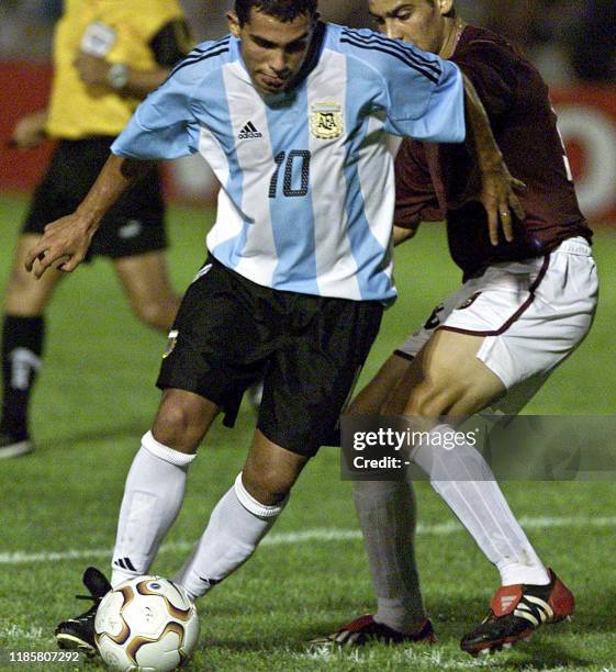 Carlos Tevez of Argentina, takes the ball from Venezuelan Gabriel Cicero, 10 January 2003, at the Campus de Colonia Stadium, 177km west of...