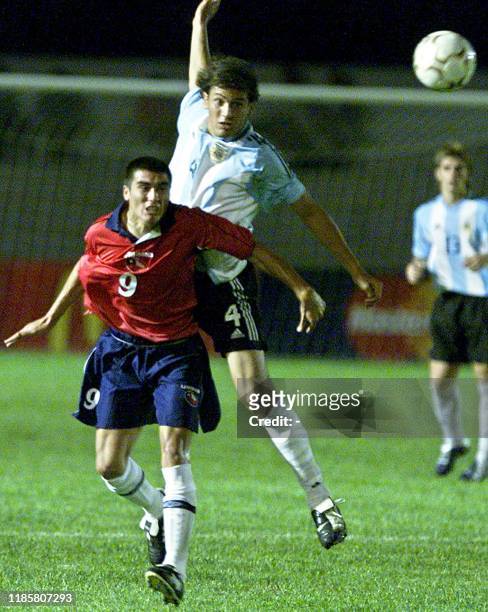 Miguel Acerva , of the Chilean team, and Mauricio Romero fo the Argentinian team, jump for the ball 08 January 2003 at the Campus Colonia Stadium in...