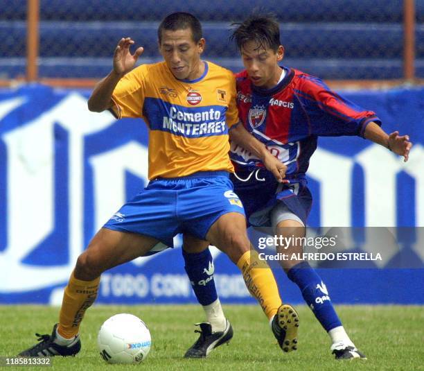 Omar Briseño of the Tigres team of the Nuevo Leon University defends the ball from Paulo Serafin of the Atlante team, in the Neza 86 Stadium, of...