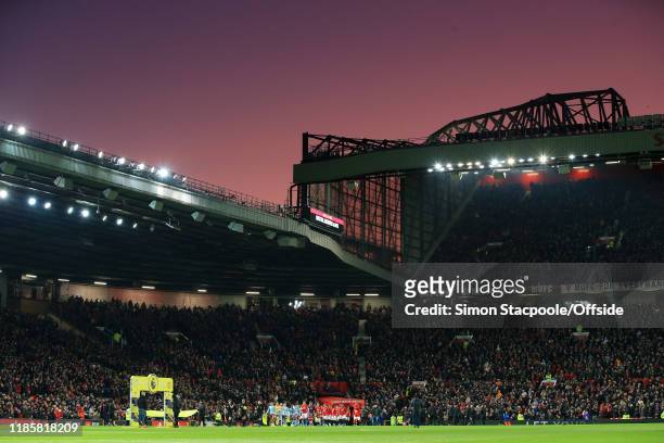 General view as the two teams walk out under a sunset for the Premier League match between Manchester United and Aston Villa at Old Trafford on...