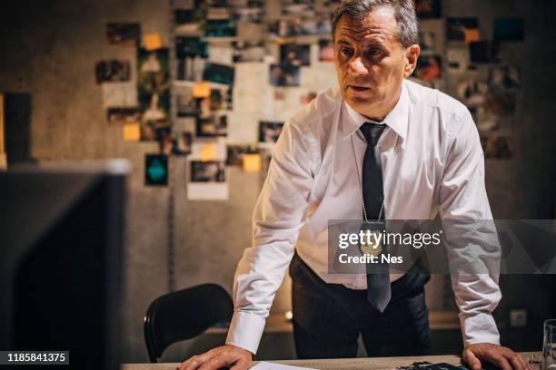 the detective himself works in the office late into the night - sergeant stock pictures, royalty-free photos & images