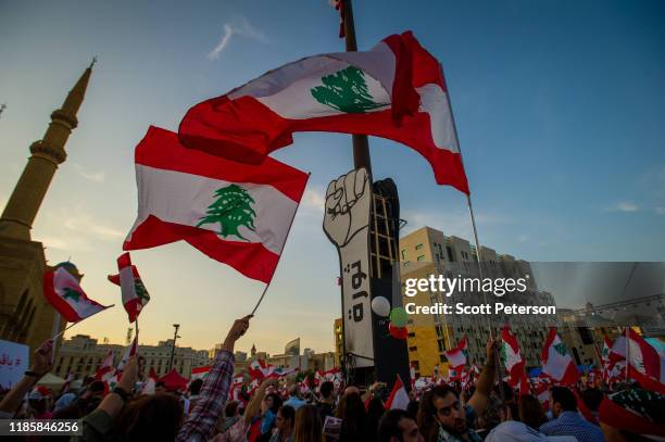 Thousands of Lebanese protesters wave flags and rally against sectarian government and call for the removal of the country's entire political class,...