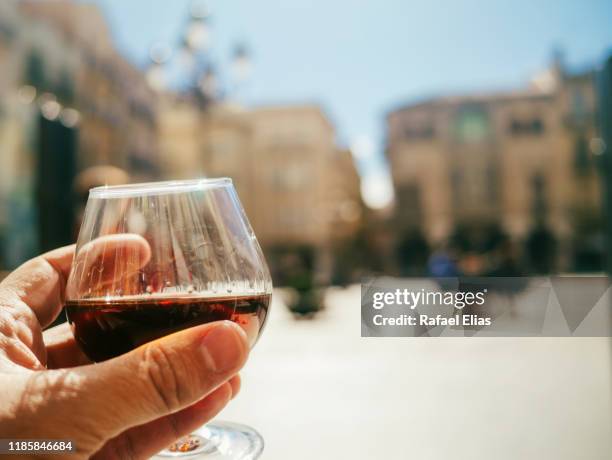 human hand holding glass of cognac - reus spain fotografías e imágenes de stock