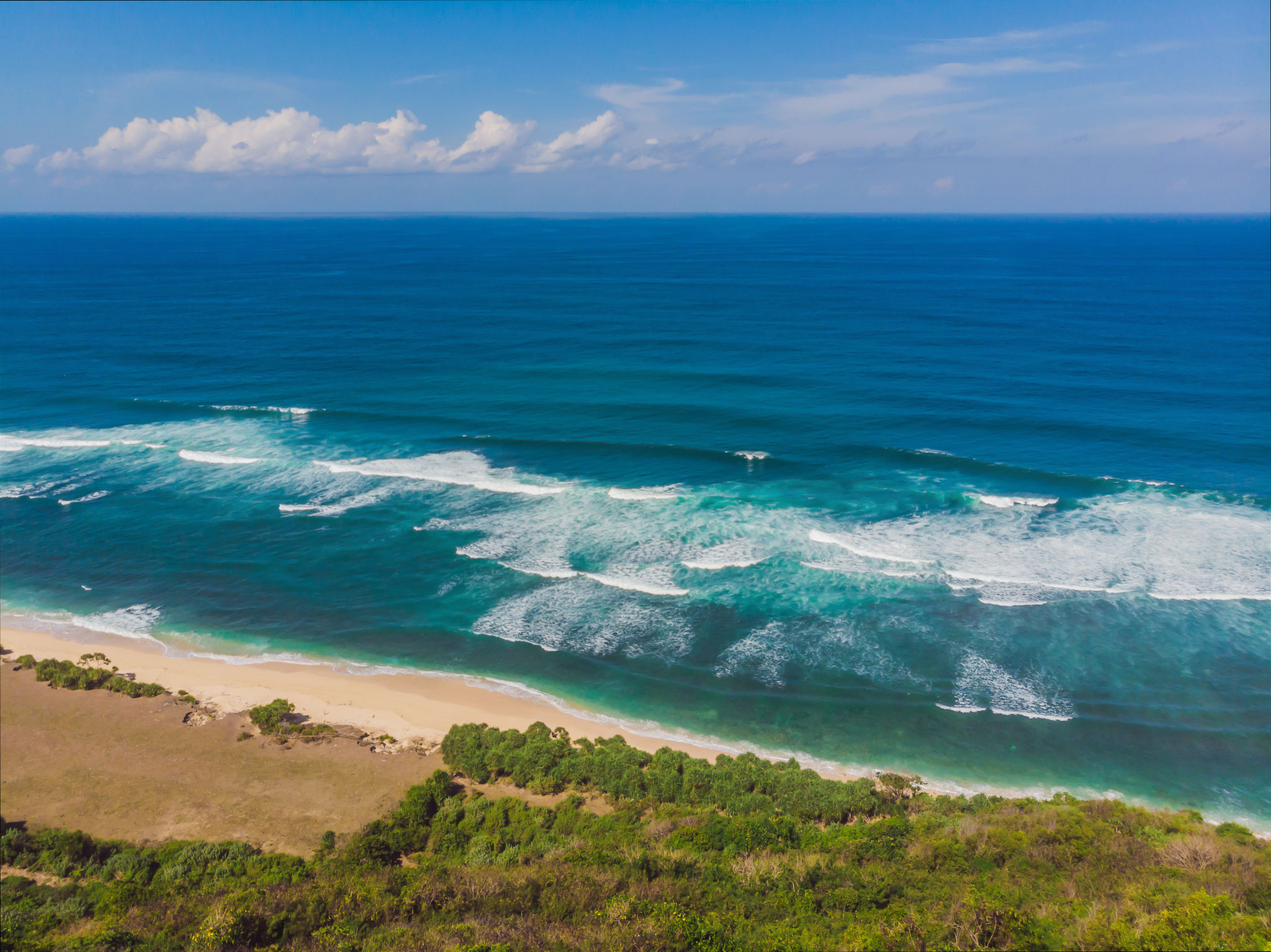 Top aerial view of beauty Bali beach. Empty paradise beach, blue sea waves in Bali island, Indonesia. Suluban and Nyang Nyang place Top aerial view of beauty Bali beach. Empty paradise beach, blue sea waves in Bali island, Indonesia. Suluban and Nyang Nyang place