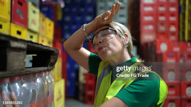 exhausted employee at warehouse - hot blondes images stock pictures, royalty-free photos & images