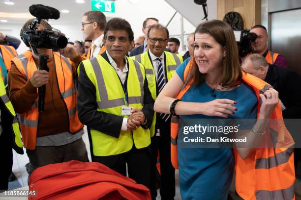 Liberal Democrats leader Jo Swinson puts on na high vis vest before being shown around the warehouse during a visit to Sigma Pharmaceuticals, a...