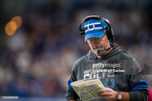 Head coach Frank Reich of the Indianapolis Colts looks at his playbook during the second quarter against the Tennessee Titans at Lucas Oil Stadium on...