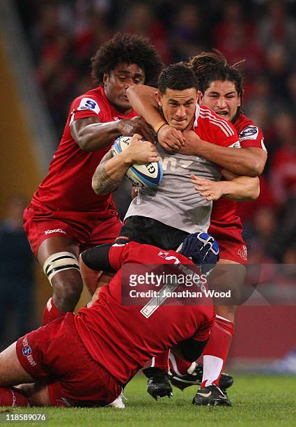 Sonny Bill Williams of the Crusaders is tackled during the 2011 Super Rugby Grand Final match between the Reds and the Crusaders at Suncorp Stadium...