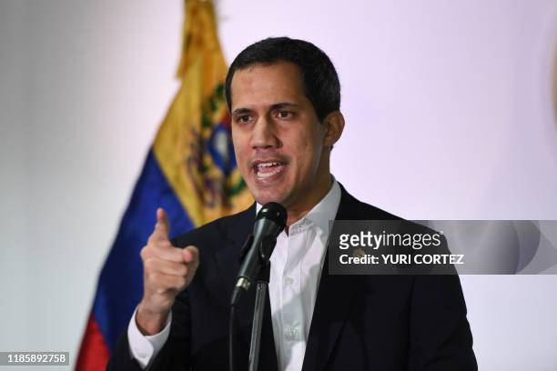 Venezuelan opposition leader and self-proclaimed acting president Juan Guaido speaks during a press conference in Caracas, on December 1, 2019. -...