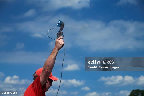 close up of an official using a gun to start an athletics race - close to finish line stock pictures, royalty-free photos & images
