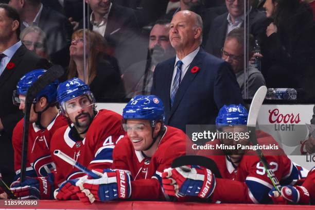 Head coach of the Montreal Canadiens Claude Julien looks on from behind the bench as he coaches in his 1,200th career NHL game against the Boston...