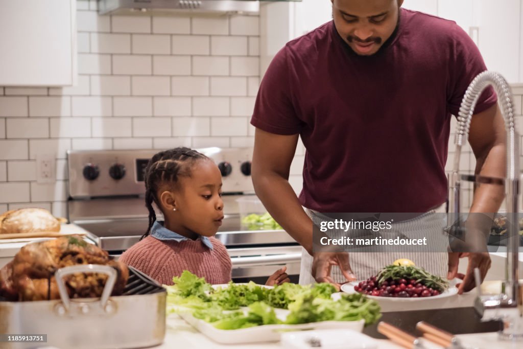 Father and young daughter preparing Thanksgiving dinner.