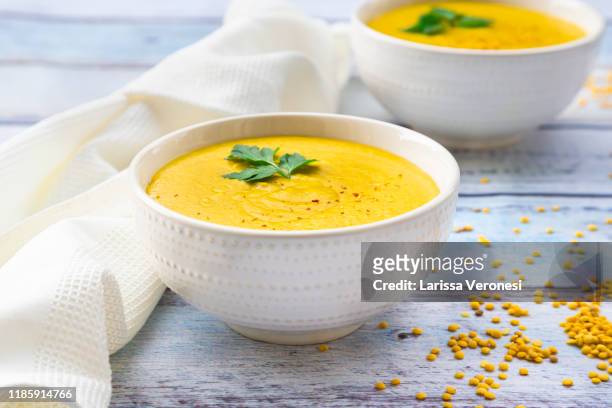 bowls with vegan yellow lentil soup - soup stock pictures, royalty-free photos & images