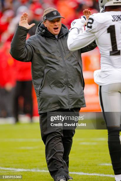 Head coach Jon Gruden of the Oakland Raiders greets Zay Jones during pregame warmups prior to the game against the Kansas City Chiefs at Arrowhead...
