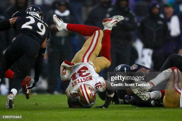 Raheem Mostert of the San Francisco 49ers is upended in the second half of the game against the Baltimore Ravens at M&T Bank Stadium on December 1,...