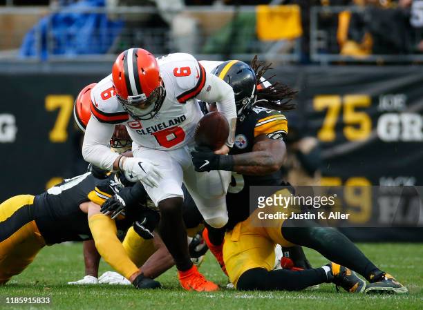 Bud Dupree and T.J. Watt of the Pittsburgh Steelers strip sacks Baker Mayfield of the Cleveland Browns in the second half on December 1, 2019 at...